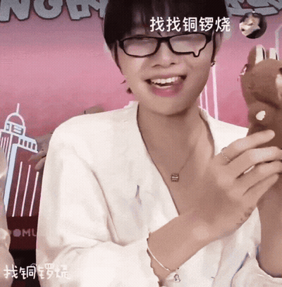 Woman With Glasses And Necklace Smiling Beside Now Sign GIF