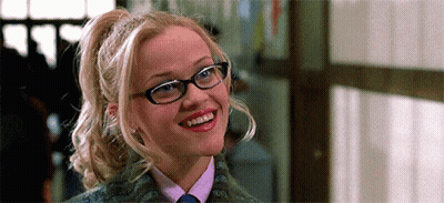 Woman With Glasses And Ponytail Smiling In Tie GIF
