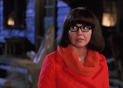 Woman With Glasses And Red Scarf Making A Face GIF
