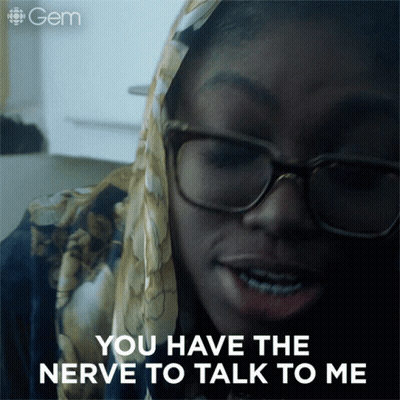 Woman With Glasses And Scarf Saying You Have Nerve GIF