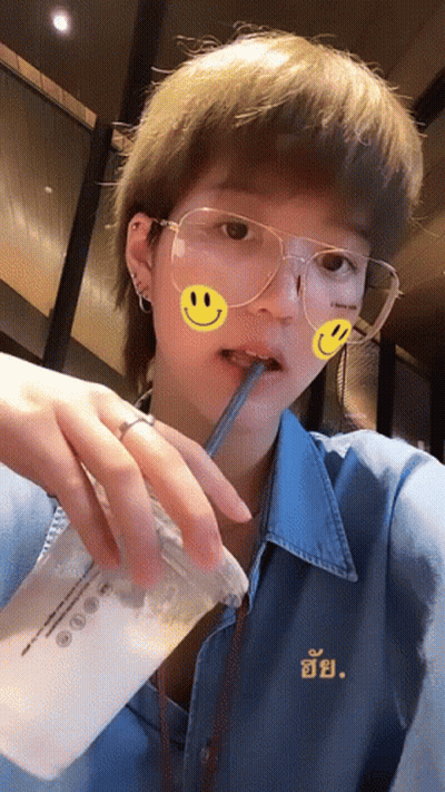 Woman With Glasses And Smiley Face Drinking GIF