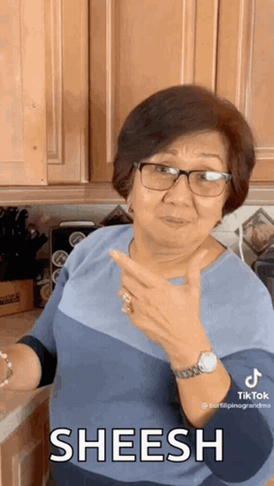 Woman With Glasses And Watch Giving Thumbs Up In Kitchen GIF