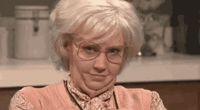 Woman With Glasses And Wig Making Funny Face GIF