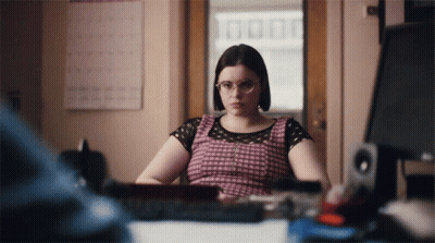 Woman With Glasses At Desk With Computer Monitor GIF