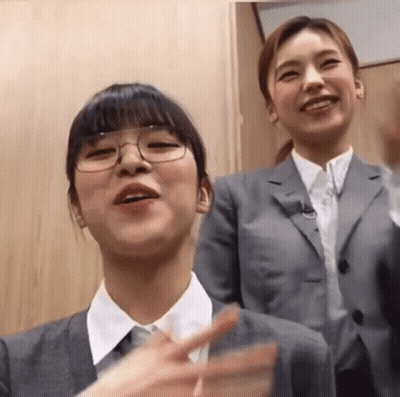 Woman With Glasses Beside Woman In Suit And Tie GIF
