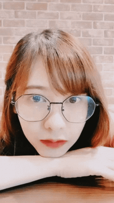 Woman With Glasses Hand On Chin GIF