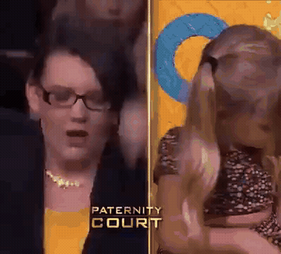 Woman With Glasses Holding Child At Paternity Court GIF