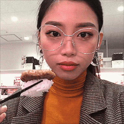 Woman With Glasses Holding Food GIF