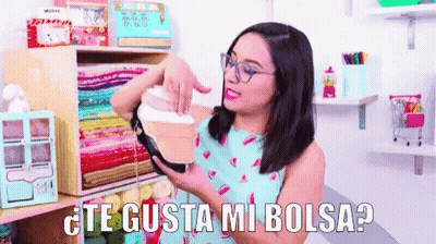 Woman With Glasses Holding Purse Saying Te Gusta Mi Bolsa GIF