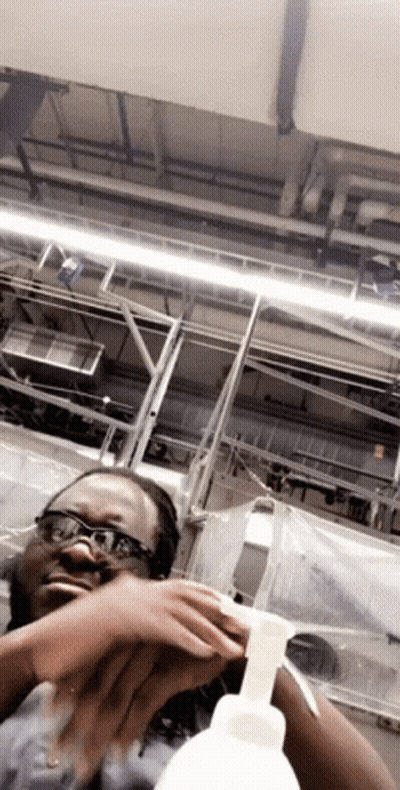 Woman With Glasses Holding Soap Bottle GIF