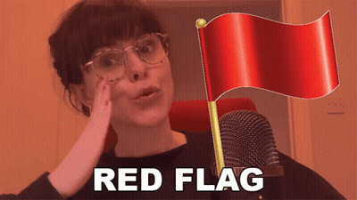 Woman With Glasses Holds Red Flag And Microphone Saying Red Flag GIF