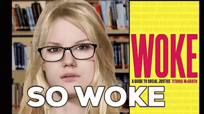 Woman With Glasses In Front Of Book Called Woke GIF