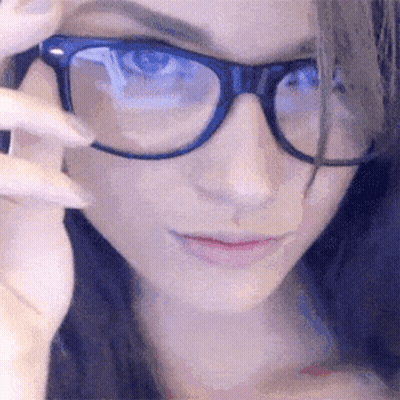 Woman With Glasses Looking At Camera GIF