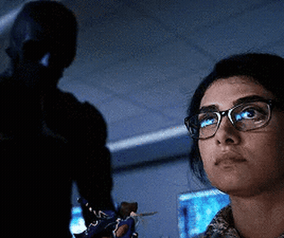 Woman With Glasses Looking In Dark Room With Man GIF