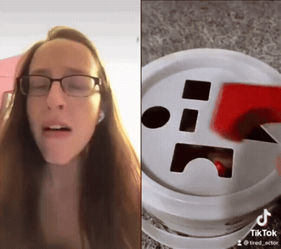 Woman With Glasses Next To Tik Tok Bucket GIF