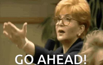 Woman With Glasses Saying Go Ahead Hands Outstretched GIF