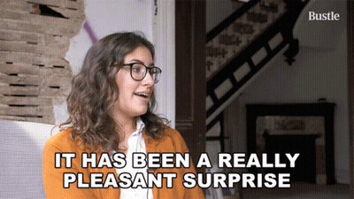 Woman With Glasses Saying Pleasant Surprise GIF