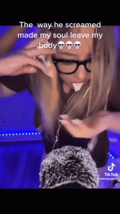 Woman With Glasses Screaming Holding Stuffed Animal In Mouth GIF