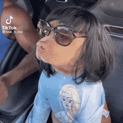 Woman With Glasses Screaming Holding Stuffed Animal In Mouth GIF