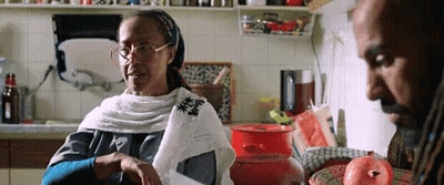 Woman With Glasses Sitting In Kitchen With Man GIF