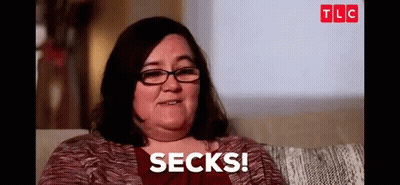 Woman With Glasses Sitting On Couch Says Socks GIF