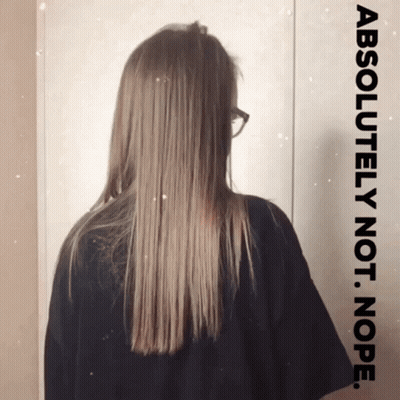 Woman With Glasses Standing Before Absolutely Not Nope Sign GIF