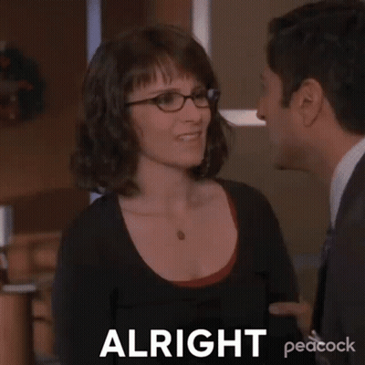 Woman With Glasses Telling Man In Suit Alright GIF