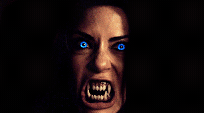 Woman With Glowing Blue Eyes And Teeth GIF