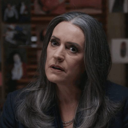 Woman With Gray Hair Looking At Camera GIF