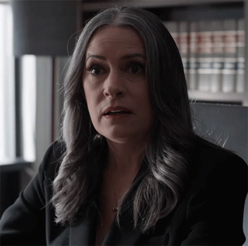 Woman With Gray Hair Looks At Camera GIF