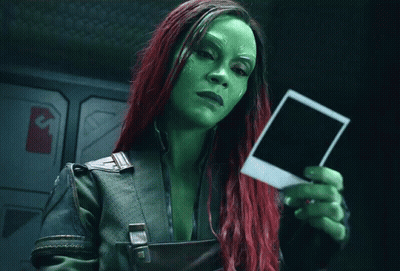 Woman With Green And Red Hair Holding Polaroid GIF