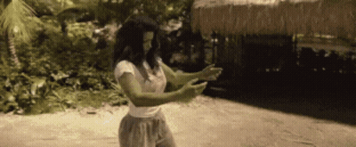 Woman With Green Arms And Legs Standing On Beach GIF