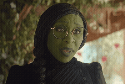 Woman With Green Face Paint And Glasses In Black Dress GIF