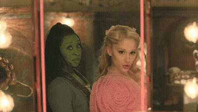 Woman With Green Face Standing Next To Woman GIF
