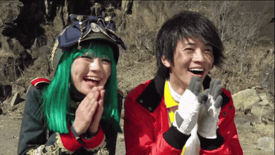 Woman With Green Hair And Man In Red Jacket Laughing GIF