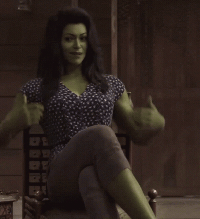 Woman With Green Muscles Sitting Cross-Legged GIF
