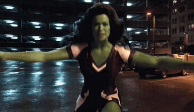 Woman With Green Muscles Standing In Parking Garage GIF