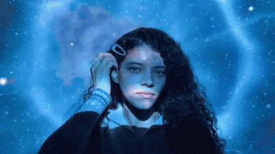 Woman With Hair Clip In Front Of Blue Background GIF
