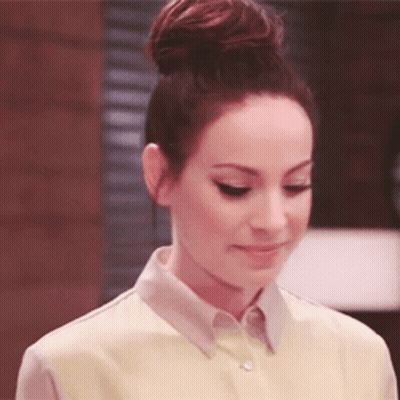 Woman With Hair In Bun Wearing Yellow Shirt GIF