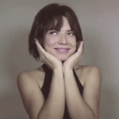 Woman With Hands on Face Smiling Up