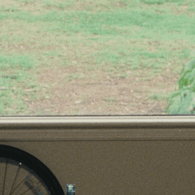 Woman With Hat And Long Hair Looking Out Window GIF