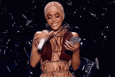Woman With Hat Holding Microphone And Phone GIF