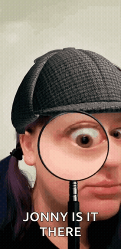 Woman With Hat Looking Through Magnifying Glass Saying Jonny Is It There GIF