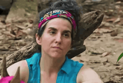 Woman With Headband And Blue Shirt Beside Log In Woods GIF