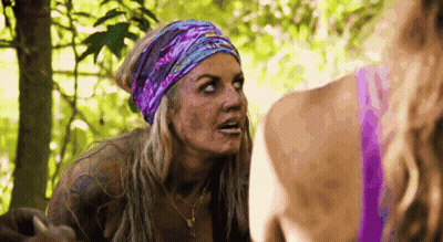 Woman With Headband And Necklace Talking To Another In Woods GIF