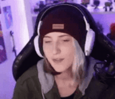 Woman With Headphones And Beanie Sitting In Chair GIF