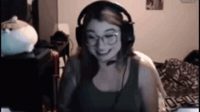 Woman With Headphones And Glasses Smiling At Computer GIF
