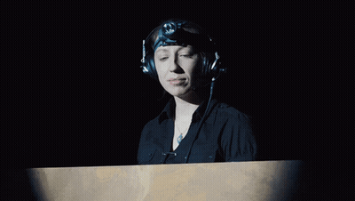 Woman With Headphones And Headlight Looking GIF