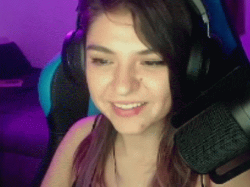 Woman With Headphones And Microphone Smiling At Computer GIF