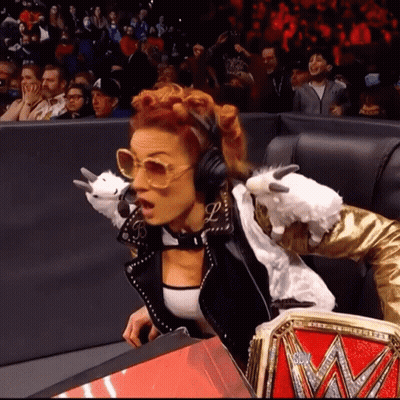Woman With Headphones And Sunglasses Holding Stuffed Animal In Crowd GIF